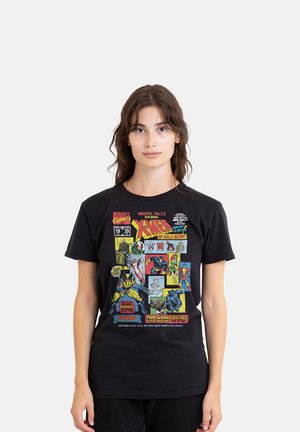 Woman with long brown hair wearing a black T-shirt with colorful vintage X-Men comic book cover art.