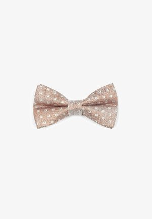 Bow tie in light brown textured fabric with white polka dots. Centered with a smooth silver accent. Symmetrical shape with pointed ends.