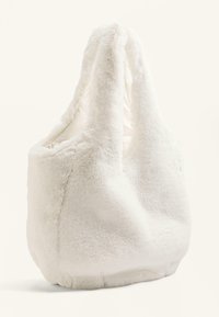 Bijela torba od umjetnog krzna sa mekom, pahuljastom teksturom, zaobljenim tijelom i dva remena za rame. Ima bešavni dizajn i mekanu podstavu.