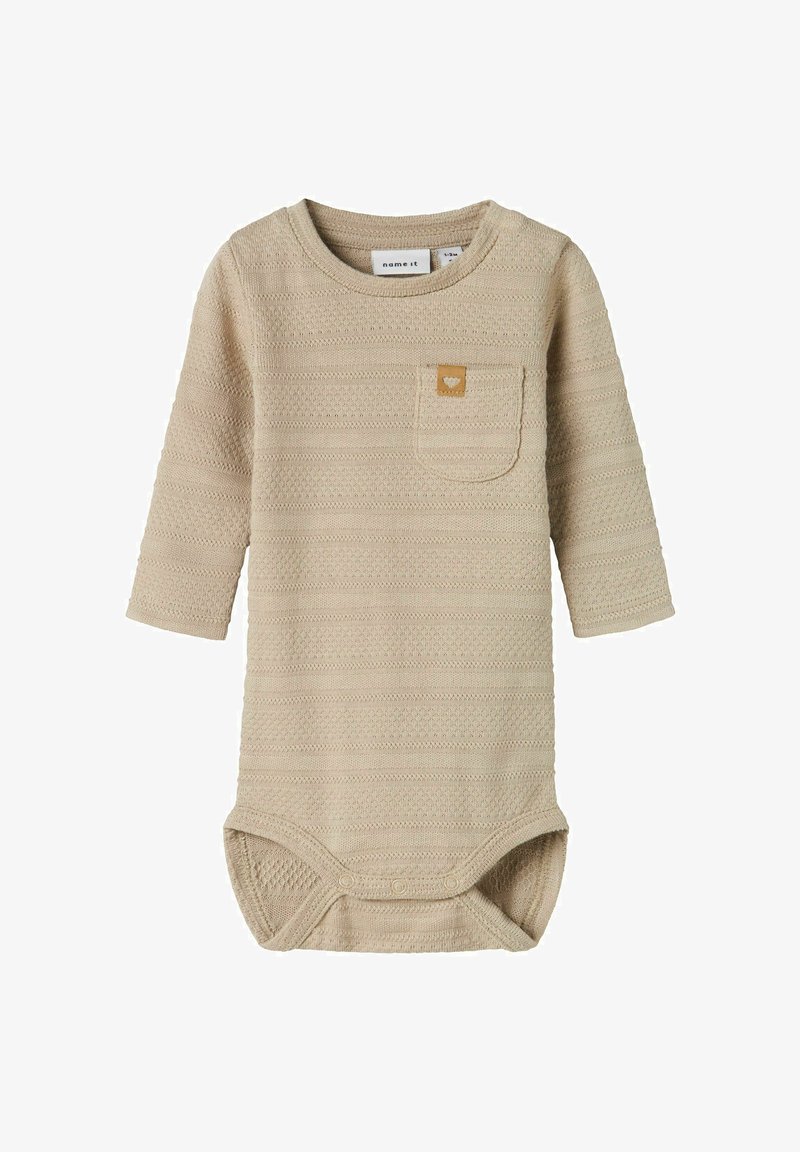 Long-sleeve bodysuit in light beige, textured fabric with horizontal stripes, featuring a small chest pocket and snap closures at the bottom.