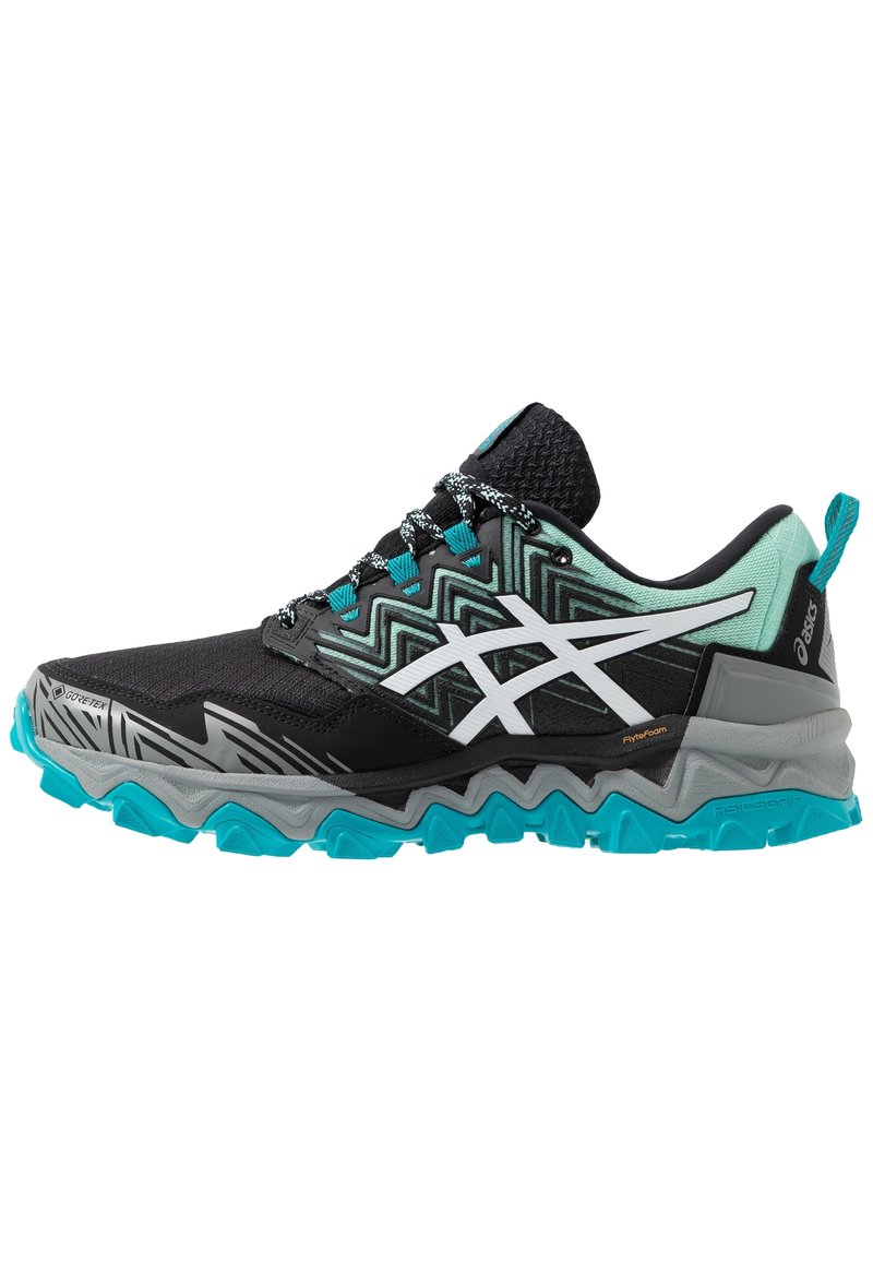 Scarpe da trail running con un design nero e turchese, dotate di una tomaia strutturata, motivi a zigzag e una suola grigia robusta con trazione.