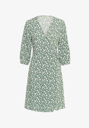 Zaļš ziedu apļa kleita no viegla auduma, ar V formas kakla izgriezumu, 3/4 garuma piedurknēm un akcentētu jostasvītru ar sasienamu detaļu. Balta margrietiņu raksts.