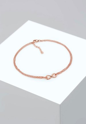 Rose gold bracelet with a chain design featuring a central infinity symbol. Smooth texture and a lobster clasp with an extender chain.