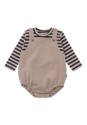 Beige textured romper with button accents over a black and white striped long-sleeve shirt, featuring elasticized leg openings.