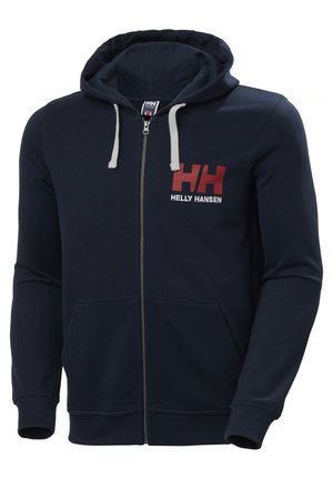 Sudadera con cremallera en color navy, con un cordón gris, bolsillos frontales y un logotipo rojo y blanco de "Helly Hansen" en el lado izquierdo del pecho. Material suave.
