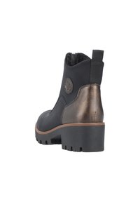 Botte de cheville en cuir noir avec un talon et un détail arrière en bronze métallique. Elle possède une semelle texturée et une doublure en tissu. Une languette latérale pour un enfilage facile.