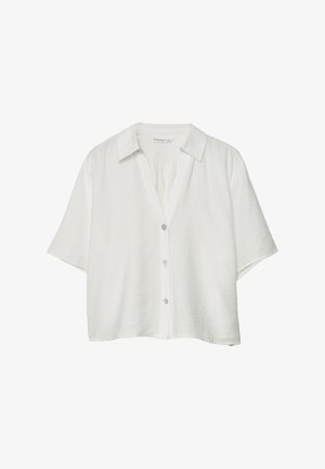 Camicia bianca a maniche corte con bottoni, colletto, vestibilità ampia e tre bottoni visibili sul davanti.