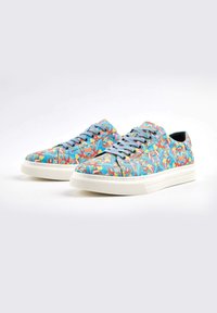 Colorful patterned sneakers with a floral design, light blue laces, and white rubber soles. Features a smooth texture and rounded shape.