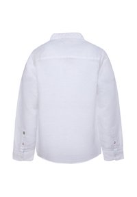 Bílé dlouhé rukávy košile z lnu. Má klasický límec, knoflíkové manžety a zakřivený lem. Neobsahuje žádné viditelné vzory ani ozdoby.