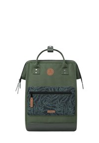 Green backpack made of durable fabric with a patterned front pocket, leather accents, and a top handle. Features zippers and a circular logo.