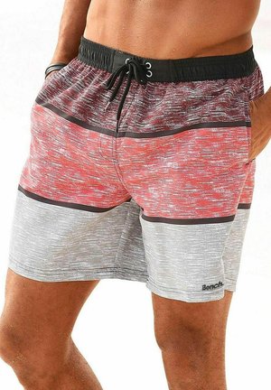 Swim shorts in red and gray with a textured pattern. Elastic waistband with drawstring and a brand logo on the lower leg.