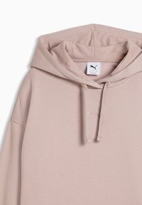 Sweat à capuche Puma rose clair avec cordons de serrage, une capuche, et un petit logo Puma brodé sur la poitrine sous l'encolure.