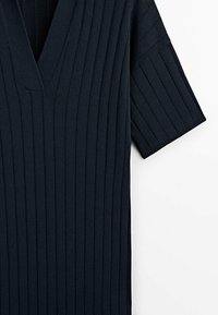 Navy blue knitted top with a V-neck, short sleeves, and vertical ribbing texture. The fabric appears soft and elastic with a fitted design.