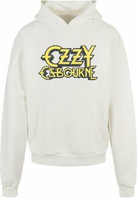 Crème hoodie met de tekst "OZZY OSBOURNE" in geel en zwart, buidelzak, geribbelde manchetten en een capuchon met trekkoord.