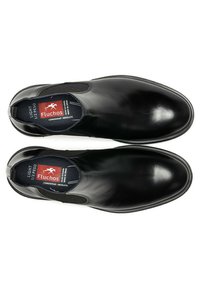 Zapatos negros de piel sin cordones, con paneles elásticos en los laterales, punta redondeada, acabado brillante y forro interior texturizado en contraste. Modelo: Fluchos.