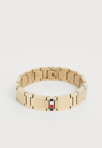 Gold-toned metal bracelet with interconnected rectangular links and a central enamel accent featuring red, white, and blue stripes.