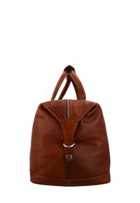 Brun läderryggsäck med rundad form, dragkedjestängning och dubbla handtag. Har en metallringdetalj på framsidan. Mjuk textur.