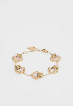 Gold bracelet featuring linked floral designs with pink accents and clear gems, intricate chain, and a triangular clasp.