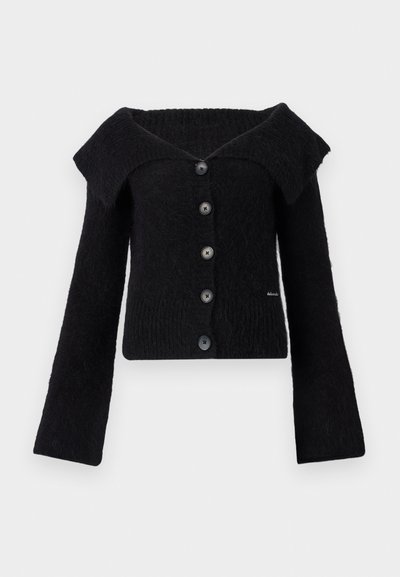 Black knitted cardigan with off-shoulder design, long flared sleeves, five black buttons, and textured fabric.