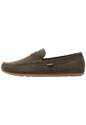 Gray suede slip-on shoes with a moccasin-style design, featuring decorative stitching and a rubber sole, suitable for casual wear.