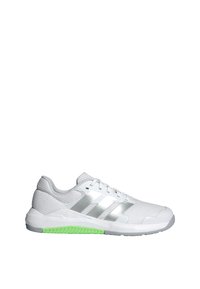 White athletic shoe with mesh upper, silver stripes, green outsole accents, and a textured design. Suitable for sports and fitness activities.