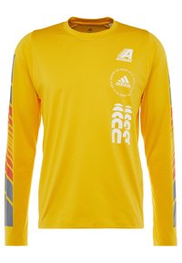 Gelbes Langarmshirt aus weichem Material, mit grauen Akzenten an den Ärmeln, auffälligen Grafiken und in Weiß bedrucktem Adidas-Logo.
