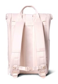Light pink backpack with padded shoulder straps, dual side pockets, and a top handle. Smooth texture and minimalist design.