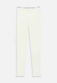 Hvide tætsiddende leggings med elastisk talje, der har Tommy Hilfiger branding og lille logo i midten.