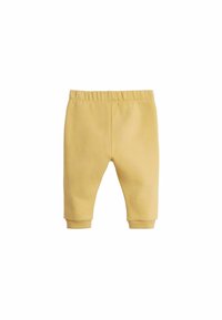 Gula bomullsjoggers med elastisk midja, avsmalnande benslut och en mjuk textur. Inga mönster eller synliga detaljer i metal.