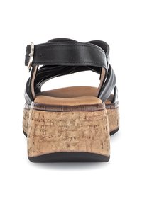 Zwarte leren sandalen met kruislings gespen, kurken platform hiel en een afgeronde teenvorm. Voorzien van een metalen gesp voor verstelbaarheid.