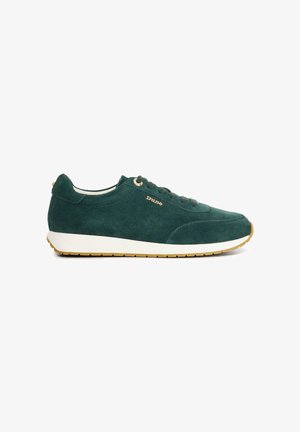 Green suede sneaker with a white rubber sole, round toe, and gold eyelets. Features a logo on the side and a smooth texture.
