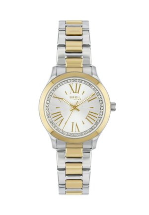 Sølv- og guldfarvet metalur med rund urskive, hvid dial, romerske tal og krystalaccenter rundt om bezel. Klassisk armbåndsdesign.