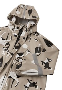 Veste de pluie beige avec un motif animal noir et blanc, capuche réglable, fermeture éclair à l'avant et poignets élastiques pour un ajustement parfait.