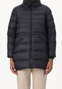 Black puffer jacket with a high collar, zip front, side pockets, and ribbed cuffs. Features quilted texture and a mid-length cut.