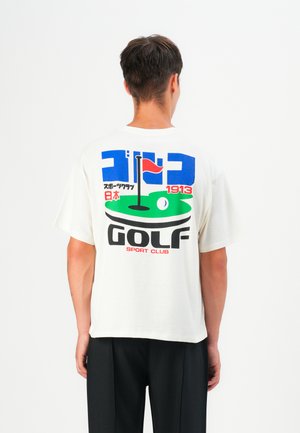 Short-sleeve, white cotton t-shirt with colorful graphic print showing a golf scene. Text includes "GOLF," "SPORT CLUB," and Japanese characters.