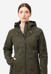 Olijfgroene waterdichte jas met een ritssluiting aan de voorkant, verstelbare capuchon, textuurstoffen en twee zijzakken. Heeft merkaccenten.