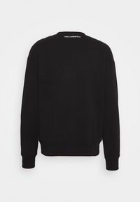 Czarna bluza z okrągłym dekoltem, długimi rękawami i ściągaczami przy mankietach. Na górnej części pleców znajduje się biały logo. Gładka tekstura.