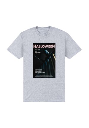 T-shirt en coton gris avec un imprimé graphique noir représentant l'affiche du film "Halloween", avec des éléments de texte blancs et rouges et une image sombre.