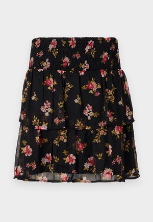 Gonna nera a fiori con vita arricciata. Presenta rouches a strati e un motivo floreale in rosa e oro su tessuto trasparente.
