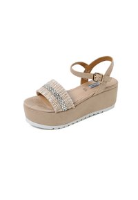 Sandalo con piattaforma beige, dotato di cinghie testurizzate, dettagli in argento e suola in gomma bianca. Presenta una cinghia alla caviglia con fibbia per una vestibilità sicura.