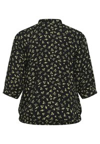 Blouse noire avec un motif floral en vert clair, dotée d'un col rond et de manches trois-quarts. Tissu doux et texturé.