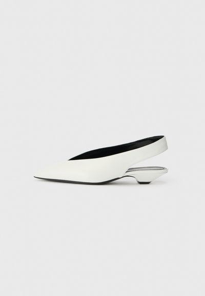 White leather slingback shoe with pointed toe, low cone heel, and black interior, featuring a sleek design and smooth texture.