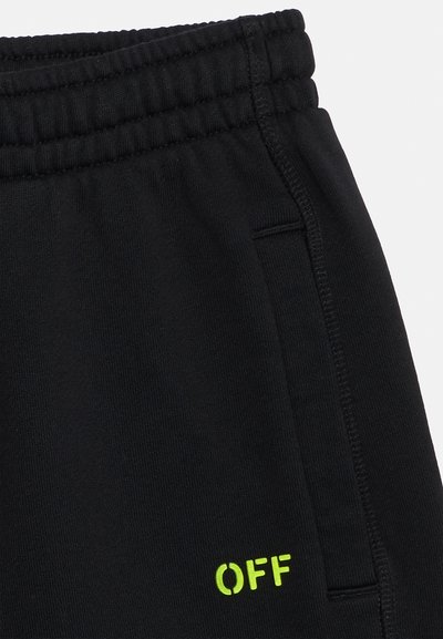Μαύροι παντελόνι με ελαστική μέση, πλαϊνή τσέπη και μικρό κείμενο "OFF" σε φωσφορίζον κίτρινο κοντά στην άκρη της τσέπης.