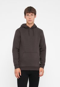 Dark brown hoodie made of soft fabric, featuring a front pocket, adjustable drawstring hood, and ribbed cuffs. Simple, solid design.