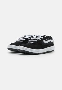 Black suede sneakers with white accents, featuring a textured upper, contrasting flat laces, and a rubber outsole. Designed with padded collars.