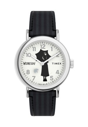 Timex watch with a silver stainless steel case, white dial, black silhouette design, black striped leather strap, and "Indiglo" feature.