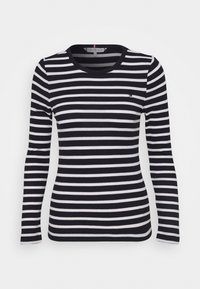 Langärmliges gestreiftes Hemd in Schwarz und Weiß, mit rundem Hals und schlanker Passform. Kleines Logo auf der Brust, weicher Rippstoff.