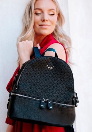 Black leather backpack with a diamond pattern, silver zipper, and logo accent. Features a rounded shape and dual shoulder straps.