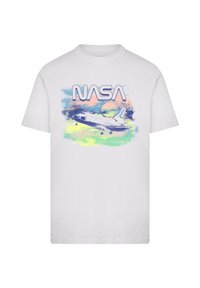 White cotton t-shirt featuring a NASA graphic with a space shuttle, abstract pastel colors, and the word "NASA" in bold, blue letters.