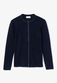 Marinblå zip-up kofta med långa ärmar, rundad halsringning, accenterande sömmar och liten broderad logotyp på bröstet. Slät textur.